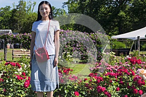 Chinese woman in a rose garden