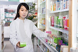 Chinese woman is searching medicines on shelves