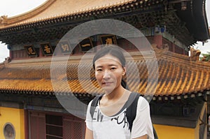 Chinese woman standing before buddhist hall