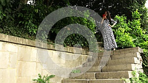Chinese woman talking on a cell and very happy and excited outdoors on a stone stairways