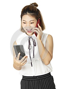 Chinese woman talking on two smart phones at the same time isolated on a white background
