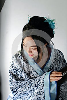 Chinese woman in traditional Blue and white Hanfu dress Stand on the stairs