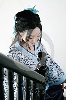 Chinese woman in traditional Blue and white Hanfu dress Stand on the stairs