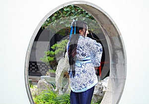 Chinese woman in traditional Blue and white Hanfu dress Standing in the middle gate