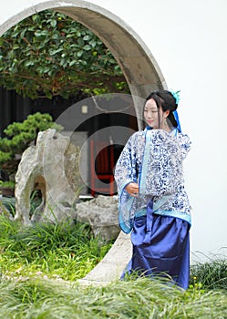 Chinese woman in traditional Blue and white Hanfu dress Standing in the middle gate