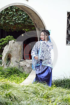 Chinese woman in traditional Blue and white Hanfu dress Standing in the middle gate