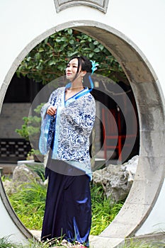 Chinese woman in traditional Blue and white Hanfu dress Standing in the middle gate