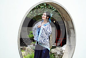 Chinese woman in traditional Blue and white Hanfu dress Standing in the middle gate