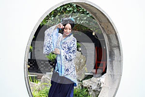 Chinese woman in traditional Blue and white Hanfu dress Standing in the middle gate