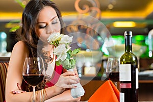 Chinese woman waiting in restaurant for date