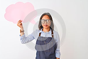 Chinese woman wearing glasses apron holding speech bubble over isolated white background with a confident expression on smart face