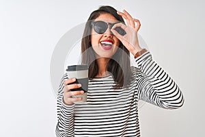 Chinese woman wearing sunglasses drinking take away coffee over isolated white background with happy face smiling doing ok sign