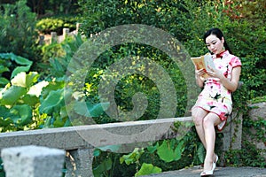 A Chinese woman wears traditional dress in the water park of Shanghai