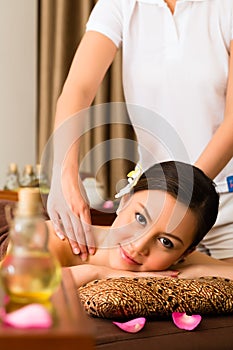 Chinese Woman at wellness massage with essential oils