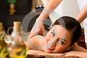 Chinese Woman at wellness massage with essential oils