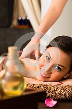 Chinese Woman at wellness massage with essential oils