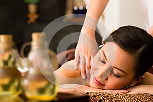 Chinese Woman at wellness massage with essential oils