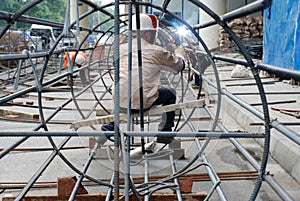 Chinese worker welding steel