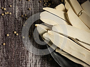 The Chinese yam or san yao on black plate on wood table for food concept