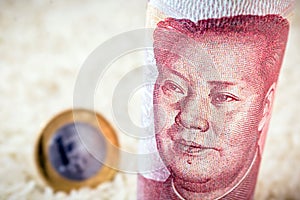Chinese 100 yen banknote with rice background and blurred currency, concept of agribusiness export and import photo