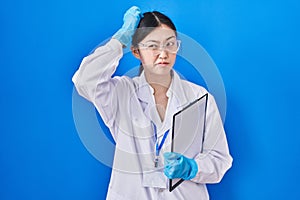 Chinese young woman working at scientist laboratory confuse and wondering about question