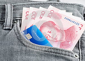 Chinese yuan banknote and credit card in the grey jean pocket