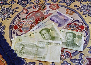 Chinese yuan banknotes on the background of national embroidery