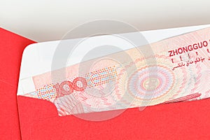 Chinese or 100 Yuan banknotes money in red envelope, as chinese