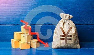 Chinese yuan or japanese yen money bag with boxes and down arrow. Income decrease, slowdown and decline of economy. Bad consumer photo