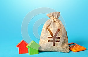 Chinese yuan or japanese yen money bag and small houses. Bank offer of mortgage loan. Investments in real estate. Sale of housing
