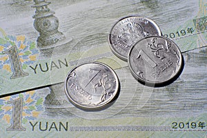 Chinese yuan money and russian rubles, close-up. Russia money coin and yuan bill from China