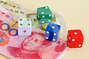 Chinese yuan or renminbi currency and dice for gambling.