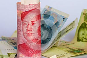 Chinese yuan or renminbi in a roll as background.