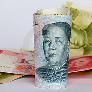 Chinese yuan or renminbi in a roll as background.