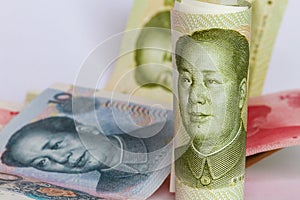 Chinese yuan or renminbi in a roll as background.