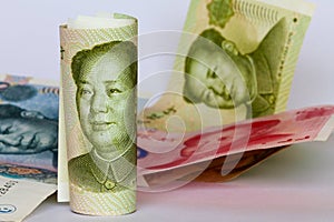 Chinese yuan or renminbi in a roll as background.