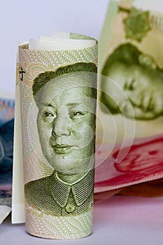 Chinese yuan or renminbi in a roll as background.