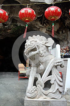 Chineselion statue stand in front of cave