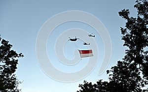 Chinook helicopter flying a giant Singapore national flag.