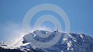 Chinook winds sweeping snow off mountain top