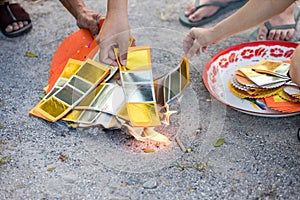 Chinses New Year. Burned paper money, gold paper. Burning the silver and gold fake money paper for Chinese dead people ancestors.