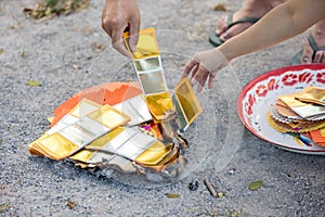 Chinses New Year. Burned paper money, gold paper. Burning the silver and gold fake money paper for Chinese dead people ancestors.