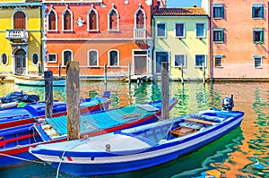 Chioggia cityscape with narrow water canal Vena with moored multicolored boats photo