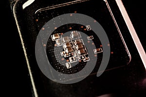 A chip in a computer with many electrical elements, a CPU, a GPU, a microchip in an electronic device