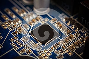 A chip in a computer with many electrical elements, a CPU, a GPU, a microchip in an electronic device