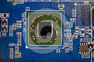 A chip in a computer with many electrical elements, a CPU, a GPU, a microchip in an electronic device