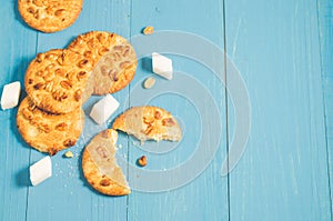 chip cookies with nuts and lump sugar /chip cookies with nuts and lump sugar on a blue wooden background, top view and copy space