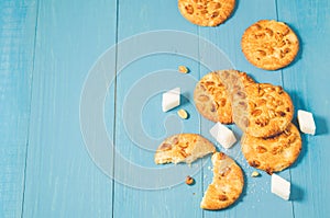 chip cookies with nuts and lump sugar. chip cookies with nuts and lump sugar on a blue wooden table, copy space