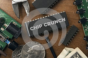Chip crunch semiconductor shortage concept: some integrated circuit and electronic stuff on a wooden table