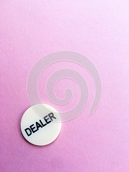 Chip dealer lies on a pink background. The game of poker. Place for text. Gambling